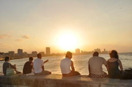 Three American friends sit with three Cuban friends, taking in the sunset together. Photo: Sonia Kovacic Three American friends sit with three Cuban friends, taking in the sunset together.
